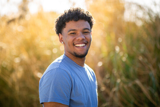 Smiling man portrait in golden sunset field