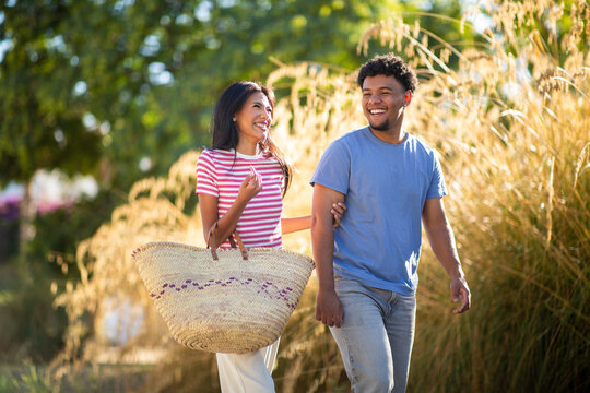Happy couple walking together in sunny park