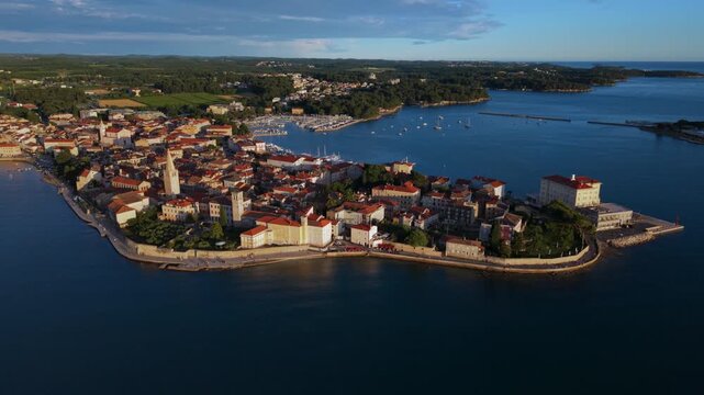 Sunset over Porec old town peninsula in Istria, Croatia. Scenic Adriatic Mediterranean coast, aerial view