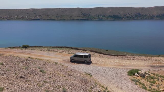 Exploring the rugged stone terrain and Martian landscape of Pag Island by camper van, Croatia. Aerial
