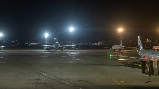 Airplanes parked on apron at night in Shota Rustaveli Tbilisi International Airport