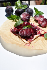 Plum Puff Pastry and Fresh Mint on whole raw plums background © Gulnaz