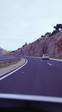 Highway drive beside mountain and going in to tunnel