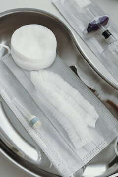 instruments in the procedure room, syringes and cotton wool in a metal injection bowl