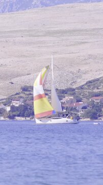 Yacht far away on sea with coast in background