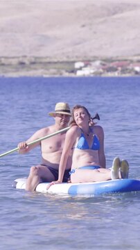 Middle age couple on sup enjoying time together