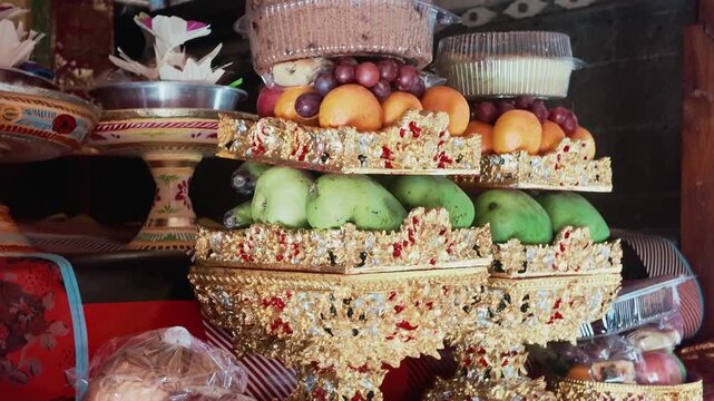 Traditional Balinese Gebogan Offering with Stacked Fruits and Cakes for Galungan Ceremony