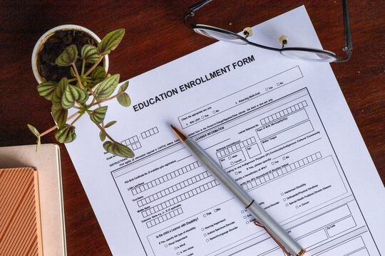 Education Enrollment Form With Pen Eyeglasses and Office Desk for School Admission Student Registration and Academic Records
