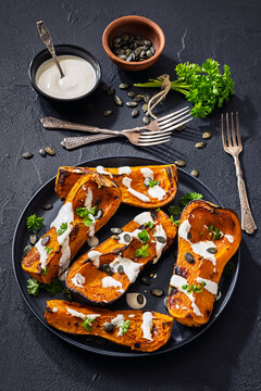 Baked butternut squash halves with yogurt sauce