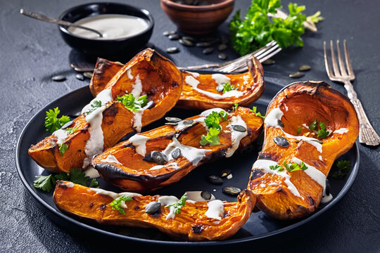 Baked butternut squash halves with yogurt sauce