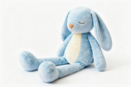 A light blue plush bunny toy with long ears, cream belly, closed eyes, seated against a plain white background.
