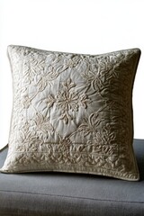 Fototapeta premium Elegant embroidered cushion with floral and snowflake patterns in neutral tones