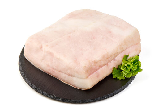 Fresh raw pork fatback with lettuce on a slate board
