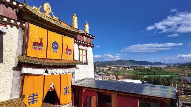 Yunnan, China : Panoramic footage of the prayer hall in the tibetan Buddhism Songzanlin Monastery overlooking the Shangri-La landscape in the mountains of Yunnan, China