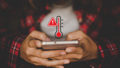 Smartphone Overheating Warning with Temperature Icon While User Holding Mobile Phone © Divyesh