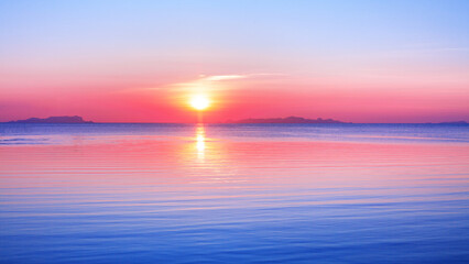 Fototapeta premium Sea beach sunset landscape, ocean sunrise panorama, paradise tropical island morning, beautiful pink red sky, gold sun reflection, blue water, relaxing calm atmosphere, idyllic nature, summer holidays