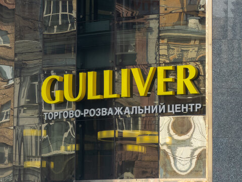 Kyiv, Ukraine - March 21, 2026: Gulliver shopping mall yellow sign on a glass facade building reflecting the city architecture and sky, conveying retail business and urban commerce