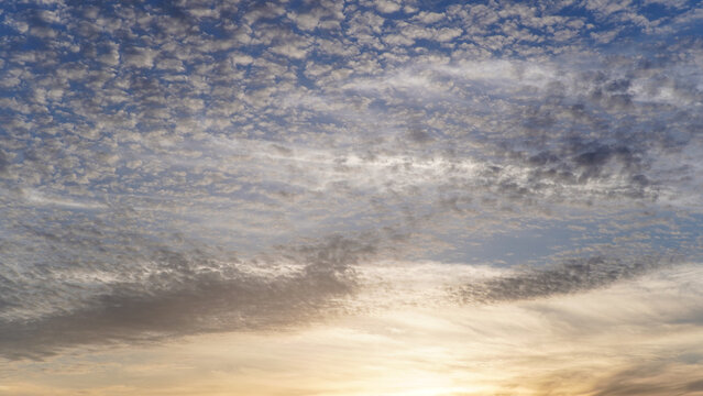 Dynamic Altocumulus Clouds and Streaks Illuminated by Golden Sunset Light