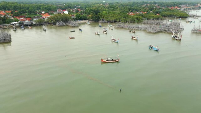 Fishing Boats And Bamboo Platforms South Coast Madura Island Indonesia Drone Track Back High Angle 4K 60FPS