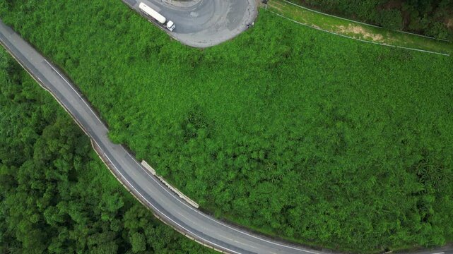 Truck Drives Uphill Twisting Hai Van Pass Danang Vietnam Jungle Drone Birdseye Shot 4K 30FPS