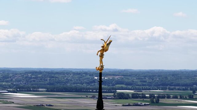 Archangel Michael gold statue top of spire Mont Saint-Michel Abbey Normandy, France landscape