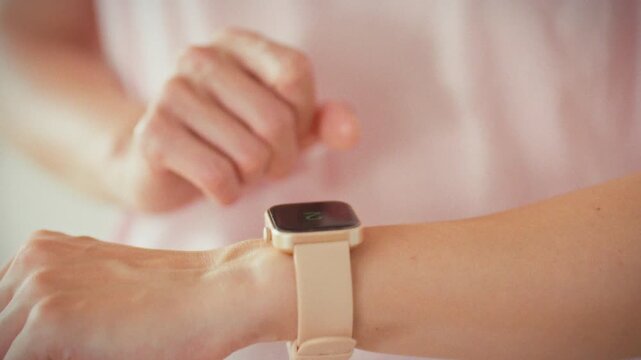 In close-up shot, a girl studies the metrics on her sleek fitness watch, merging sports and technology as she monitors physical activity data, illustrating a modern, data-driven approach to training