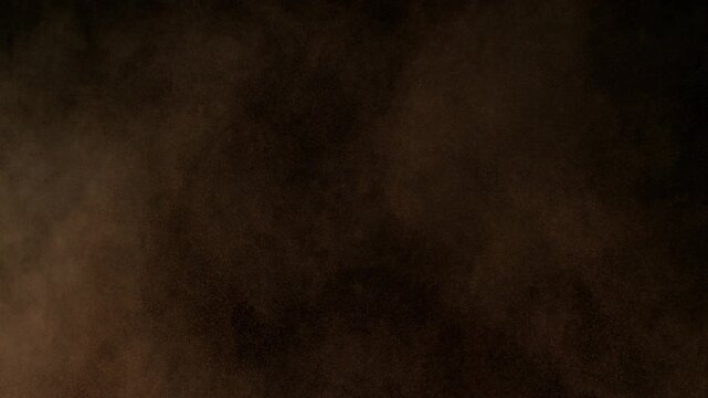 Super Slow Motion Shot of Brown Powder Particle Background Isolated on Black at 1000fps.