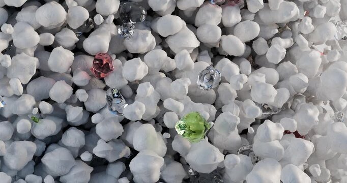 3D animation is a dense texture of many small rounded granules of white color, resembling foam or mineral filler. Among the total mass, there are single inclusions of multicolored translucent crystals
