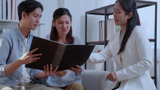 Financial advisor presenting wealth management plan to clients, real estate agent explaining property mortgage loan agreement, professional insurance consultant discussing investment contract.