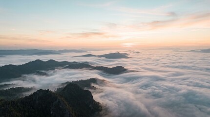Obraz premium Sunrise Over Misty Mountain Peaks and Clouds.