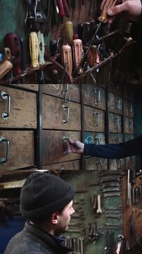 A man organizes tools in a workshop while using wrenches in a candid moment.