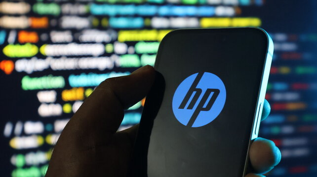 Person holding smartphone with hp logo, digital code on background, global technology brand.