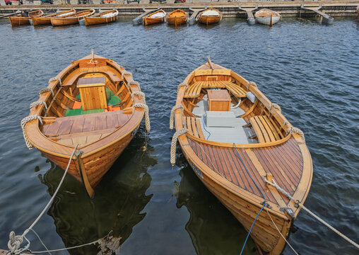 Colorful Wooden Boats Docked at Coastal Harbor with Reflective Water and Sunny Sky, Stavern, Norway