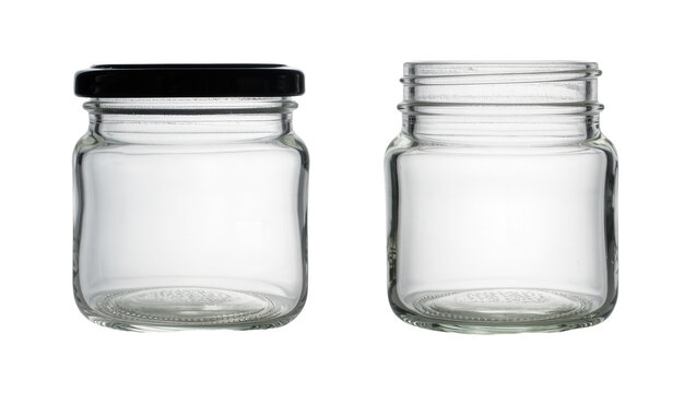 Isolated set of two empty clear glass preserve jars one with a black lid and one open