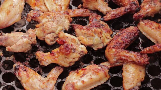 Grilled chicken wings and drumsticks, crispy and golden brown