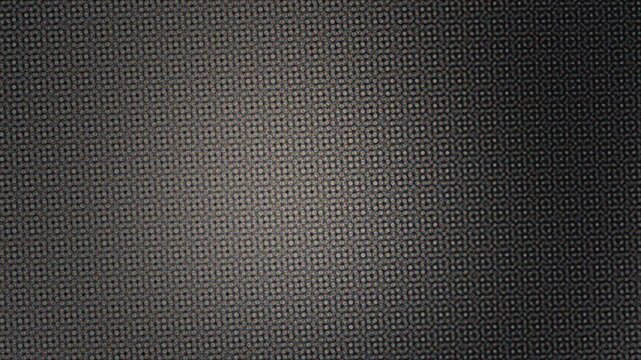 Textured black surface with subtle patterns in dim light