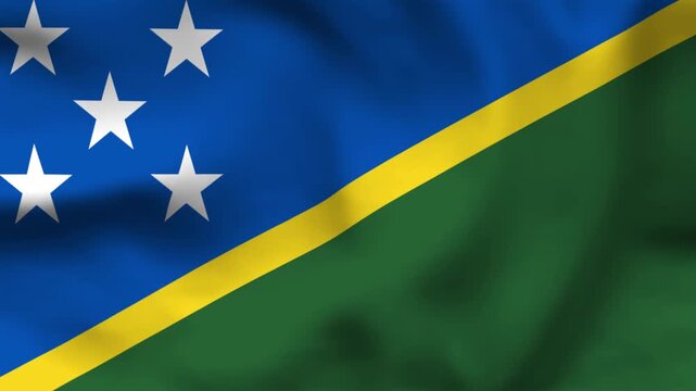 Solomon Islands flag on wavy fabric, top view. Blue and green triangles with yellow diagonal stripe and five white stars.