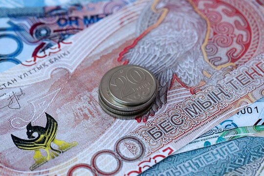 Kazakhstani tenge money bills and coins on table. Kazakhstan cash of KZT currency