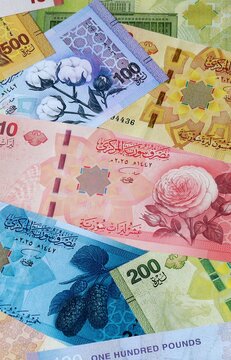 Syrian pound money banknotes bunch on table. Syria bills of SYP currency close up