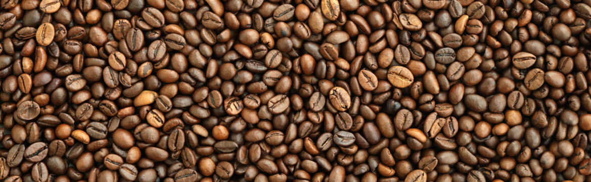 Detailed view on brown roasted coffee beans in big pile on table close up