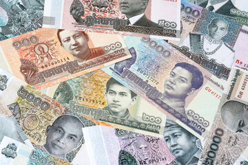 Cambodian riel money bills in pile on table. Cambodia KHR currency cash close up © Viktor