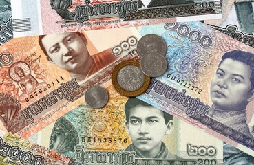 Cambodian riel money banknotes and coins on table. Cambodia cash bills of KHR currency © Viktor