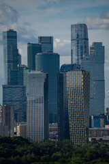 Obraz premium Epic Moscow City international business center skyscrapers vertical panorama. Cinematic view of modern futuristic office glass towers district, urban financial center facade skyscrapers and green pa