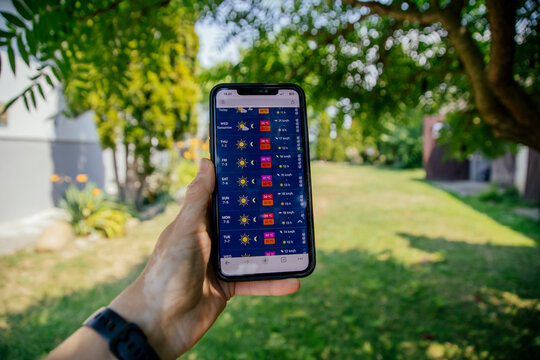 Person checking weather app. Summer heat wave concept, with over 30 degree