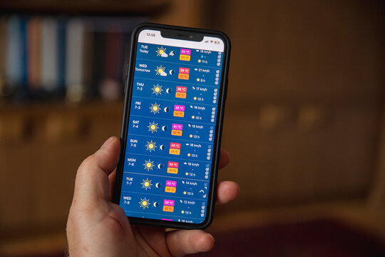 Person checking weather app. Summer heat wave concept, with over 30 degree