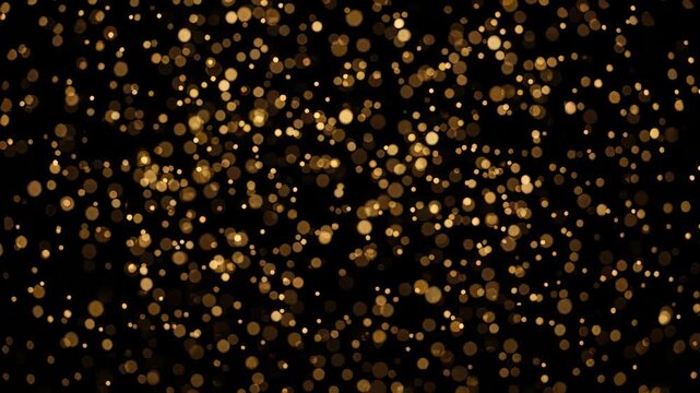Golden bokeh particles floating on black background. Abstract light shimmer effect for celebration party. Decorative shiny dust texture for luxury design concept.