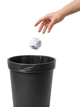 Hand throwing crumpled paper into waste basket isolated on white background