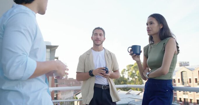 Diverse friends on roof balcony Asian man starting catchup chat gesturing while others sipping mugs