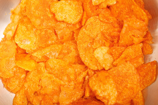 Close-up of crispy potato chips with a spicy seasoning.