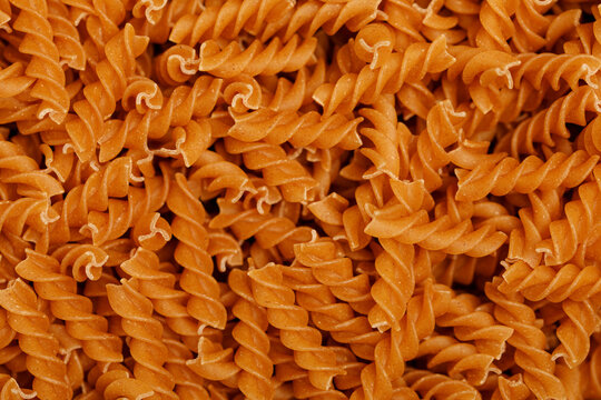 A full frame shot of dry whole wheat fusilli pasta creating an interesting texture.
